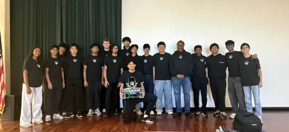 The Raiders of the A.R.C. team with their robot and their coach