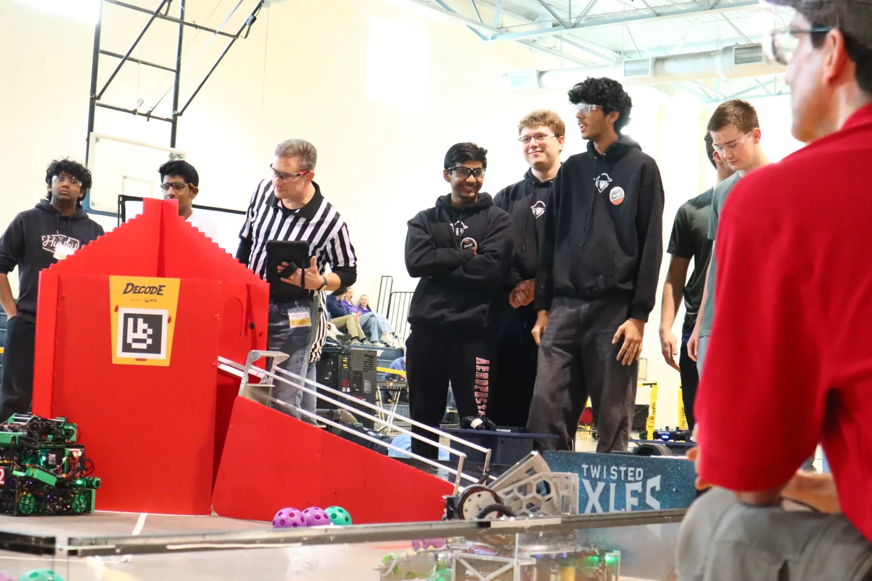 Team members watching a match from the pit wall