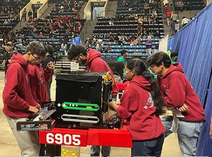 Students working on the 6905 robot at an FRC event