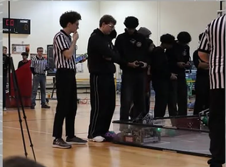 Referee and drive team at an FTC match