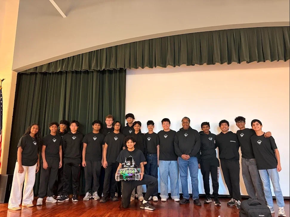 The Raiders of the A.R.C. team posed on stage with their robot