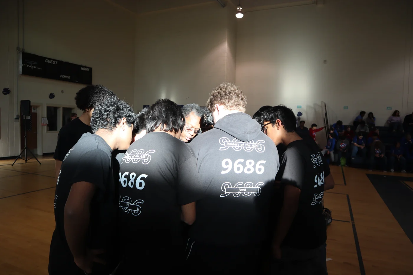 Raiders of the A.R.C. team huddled together in their 9686 shirts